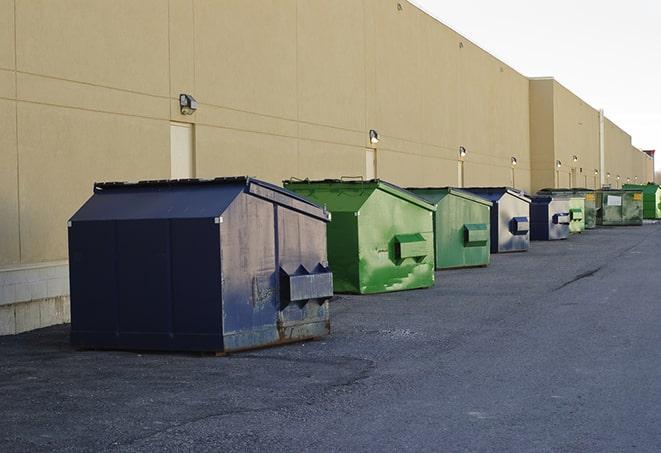 construction workers disposing of debris in large dumpsters in Dacono CO